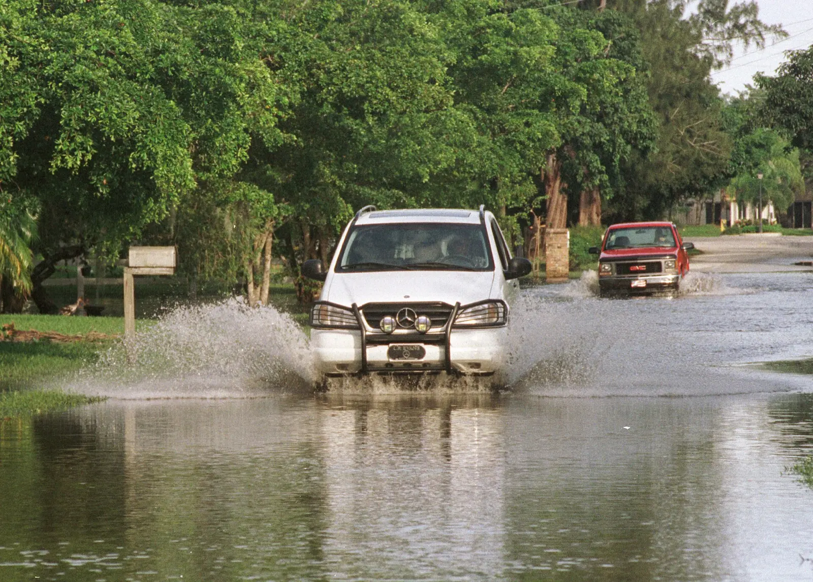 Residents on a flooded side road in Davie after Hurricane Irene dropped about 15 inches of rain in October 1999.