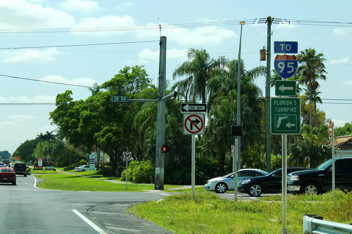 Signs for I-595 and Florida's Turnpike at the corner of NW 136th Avenue and State Road 84, on the north edge of the Shenandoah area.