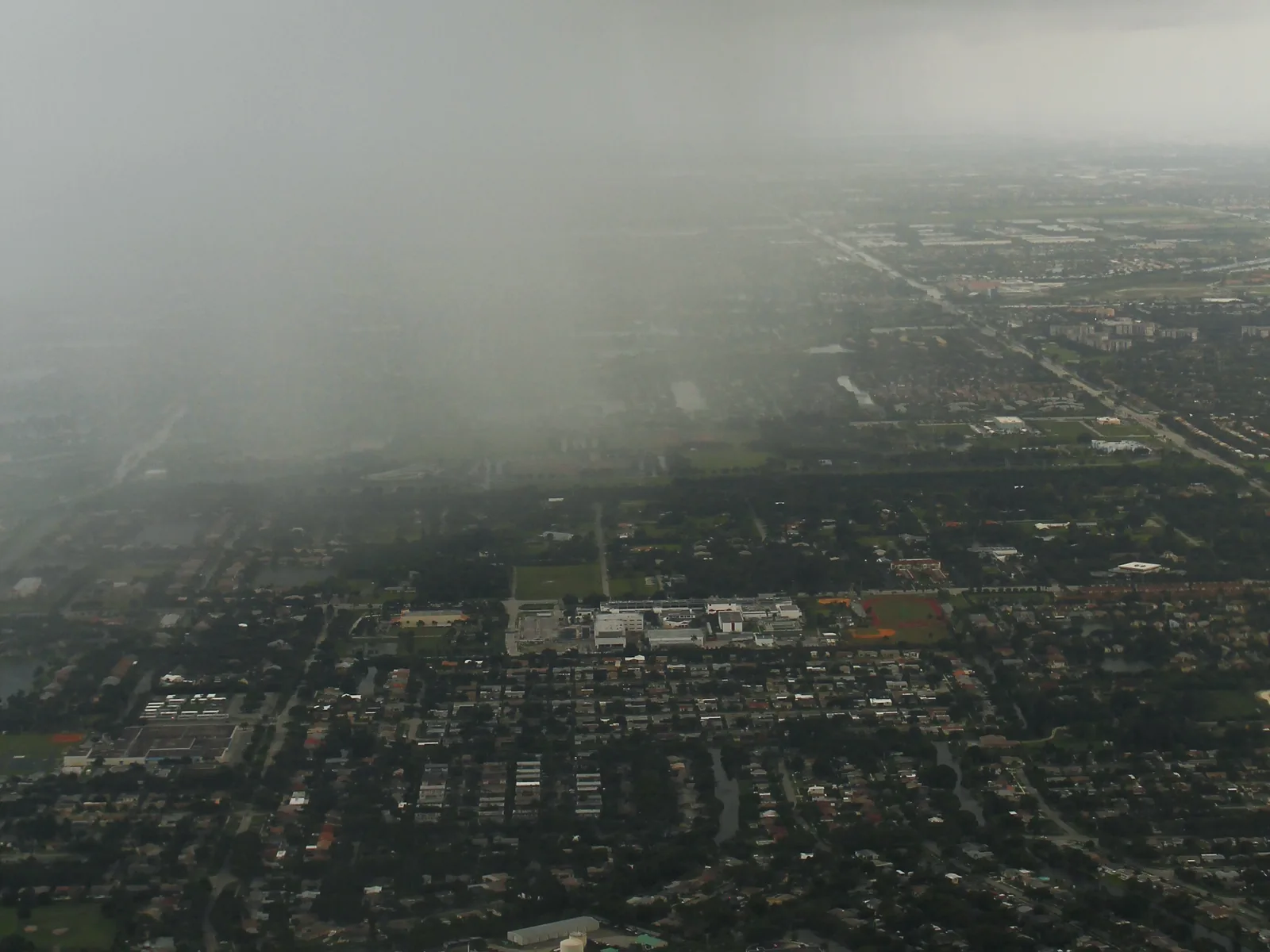 A summer rain shower over Davie, photographed from the air near University Drive in July 2013.