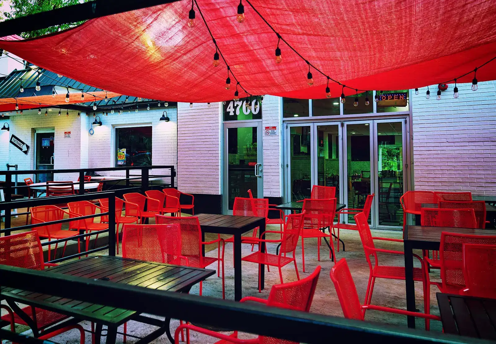 Tables and umbrellas at a sidewalk cafe. The photo was not taken in Davie.